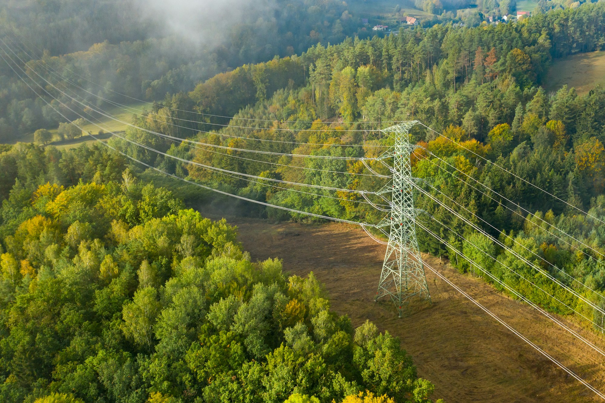 Aerial view of the high voltage power lines and high voltage electric transmission on the terrain