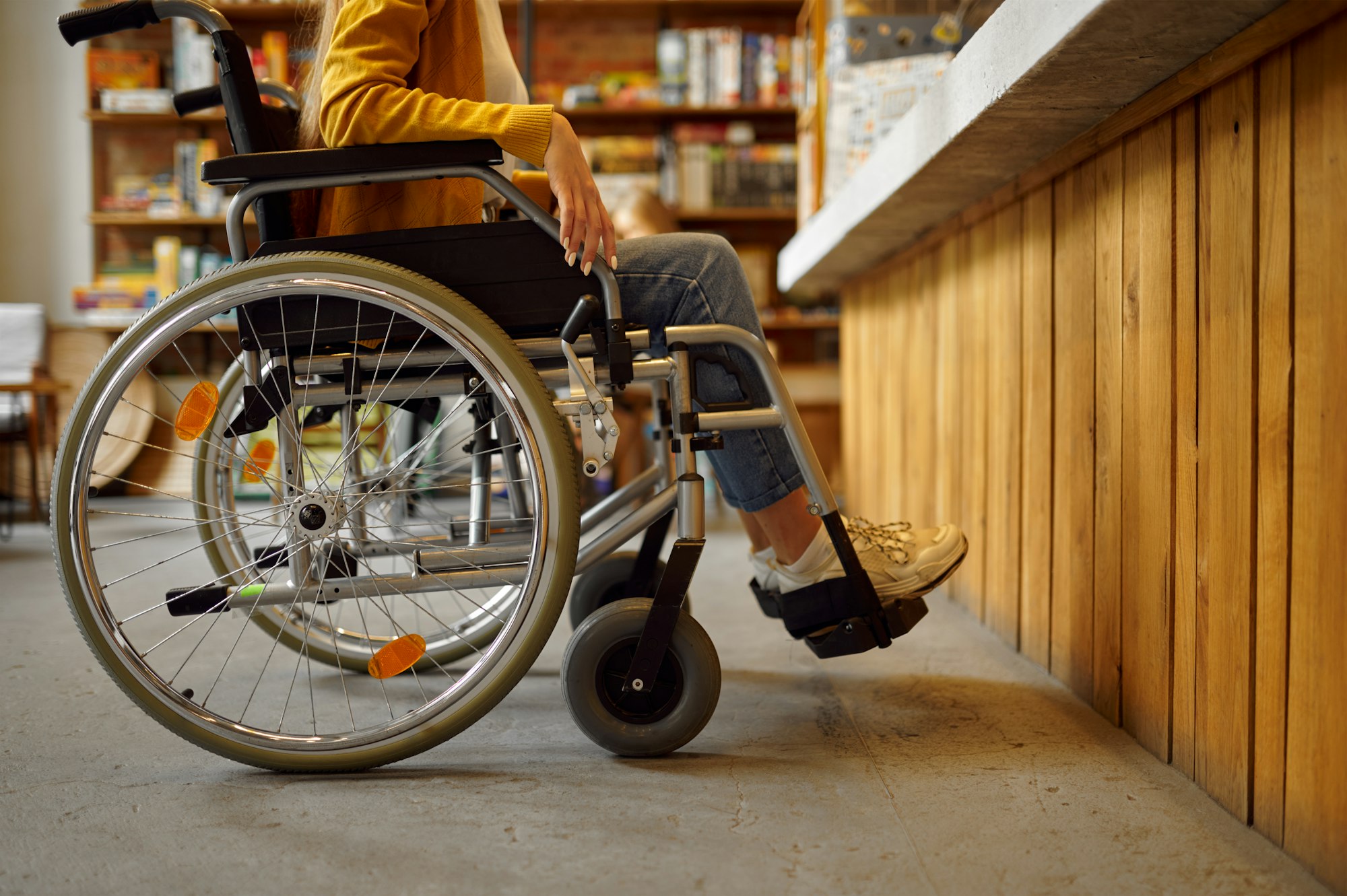 Disabled female student in wheelchair at counter